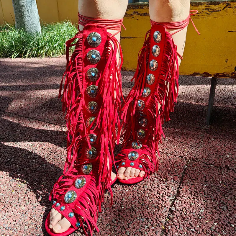 Full view of red fringed gladiator sandals styled on legs