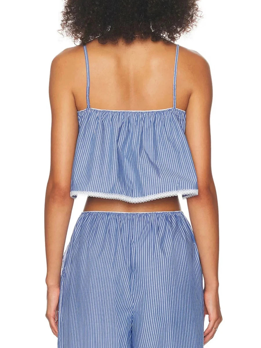 Person wearing a blue and white striped top and pants on a white background