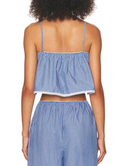 Person wearing a blue and white striped top and pants on a white background