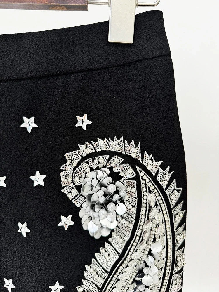 Black skirt with white paisley pattern and star designs on a white background