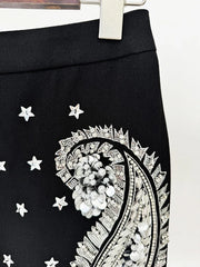 Black skirt with white paisley pattern and star designs on a white background
