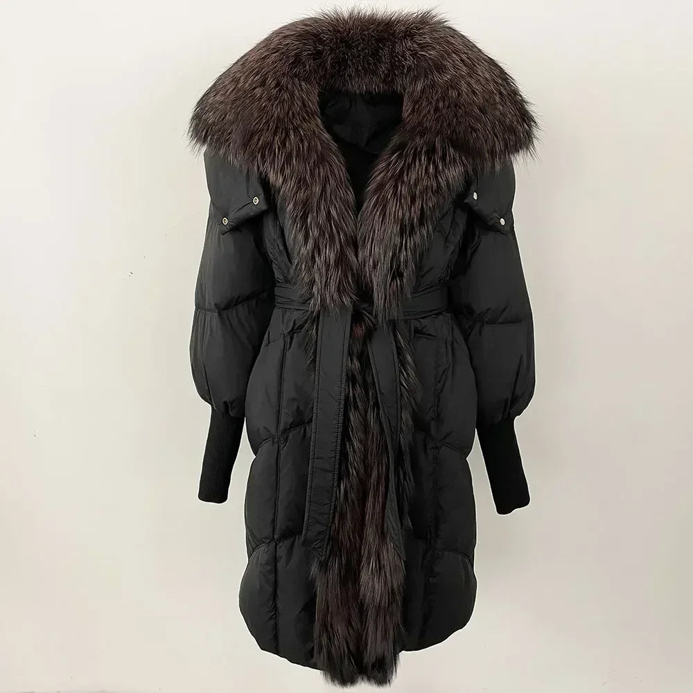 Black winter coat with fur hood and belt on a light beige background
