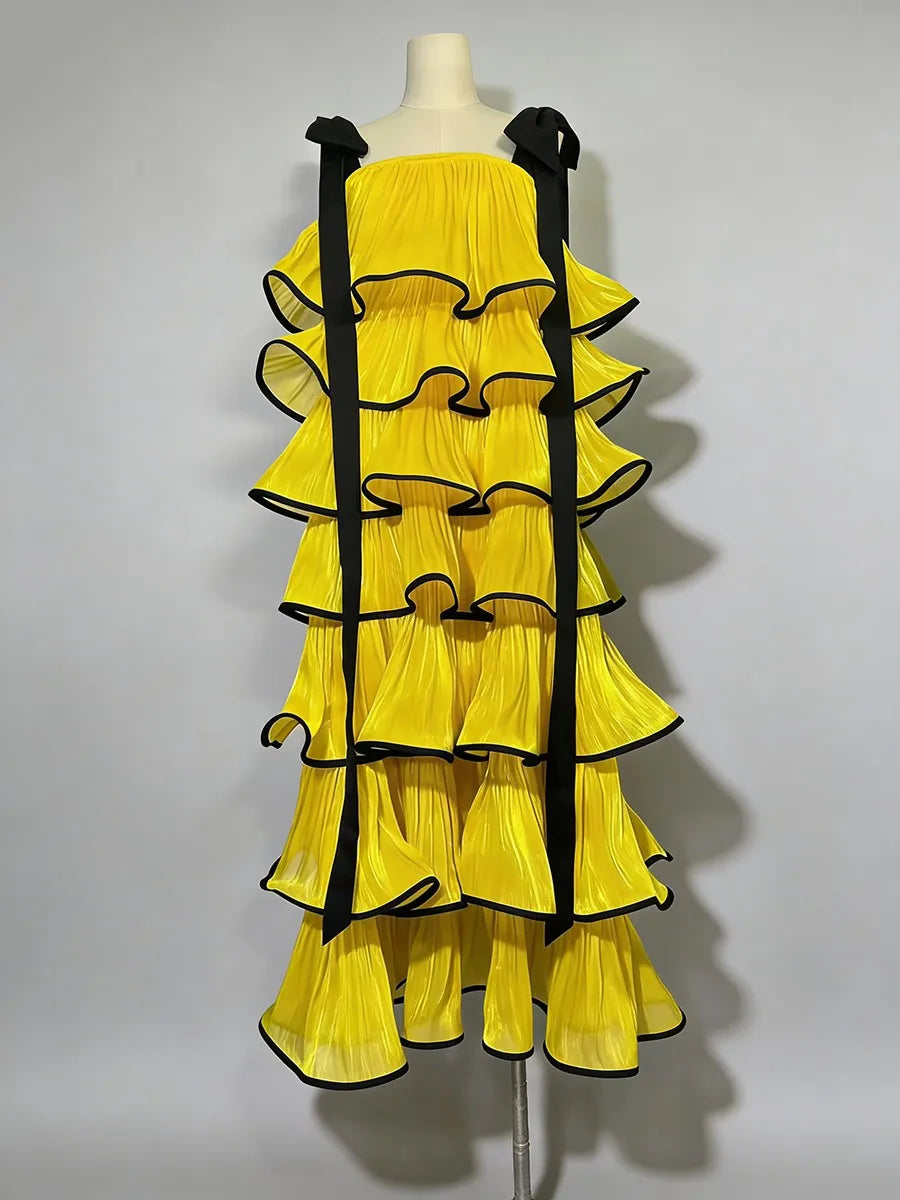 Yellow dress with black trim on a mannequin against a gray background