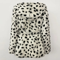 White fur coat with black spots on a light gray background