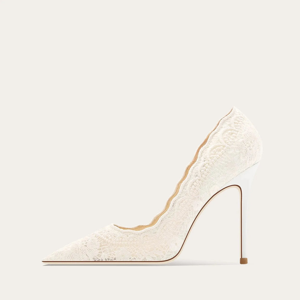White high-heeled shoe with a thin heel on a light beige background