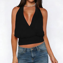 Person wearing a black halter top and blue jeans on a white background