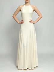 Front view of a sleeveless halter neck maxi dress with a pleated A-line skirt.