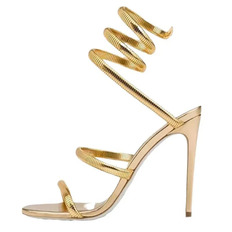 Gold high-heeled sandal with spiral design on a white background
