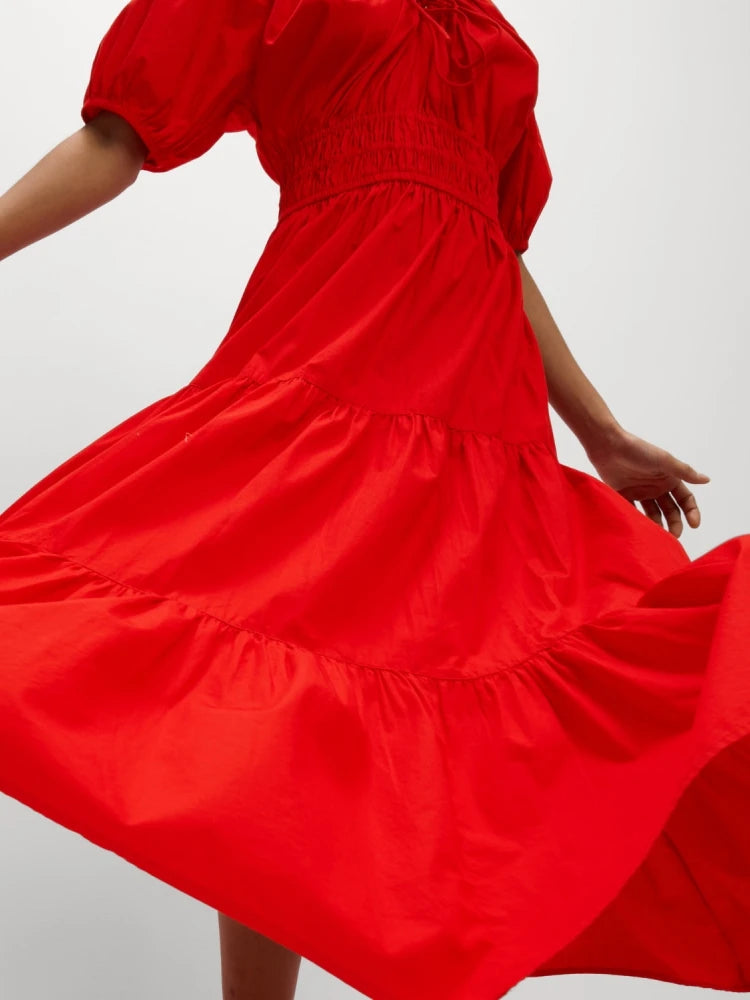 Red dress with puff sleeves on a plain background