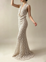 Model posing in a sleeveless hollow out lace maxi dress