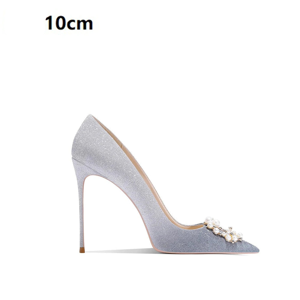 High-heeled shoe with decorative elements on a white background