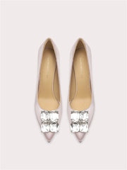 Pair of light pink high heels with crystal embellishments on a white background