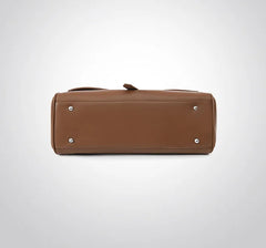 Brown leather handbag on a light gray background