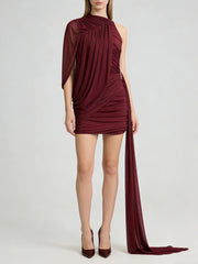 Burgundy one-shoulder dress with a long train on a white background