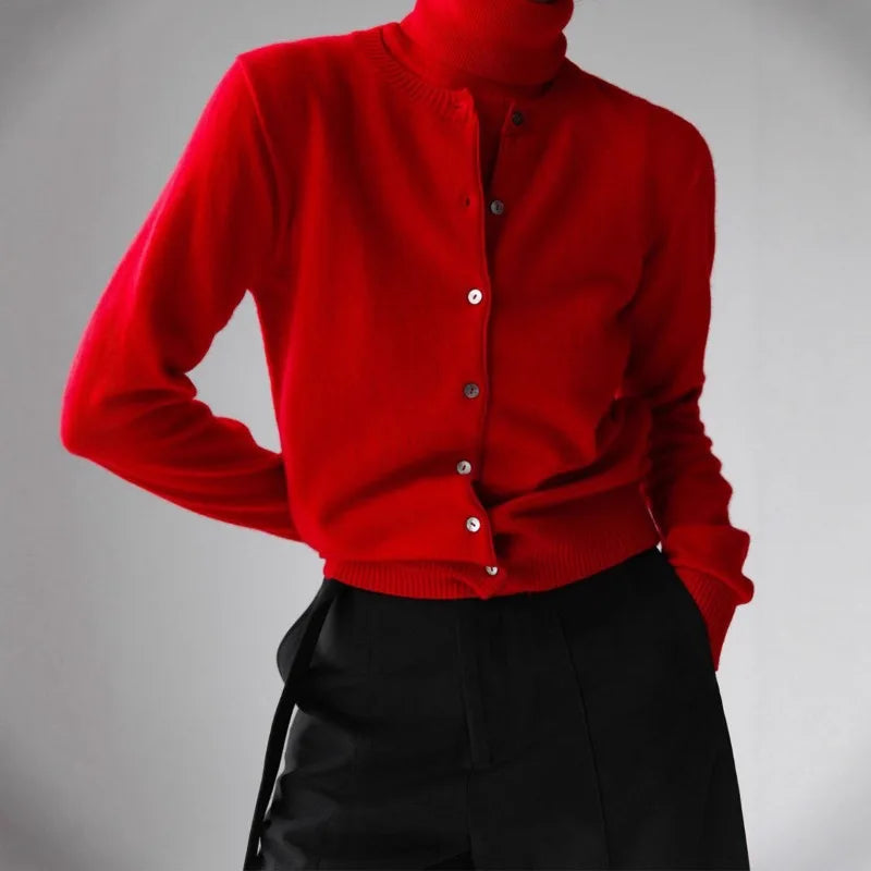 Red cardigan with black pants on a gray background