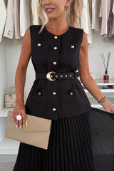 Woman wearing a black sleeveless jacket with gold buttons and a beige clutch in a clothing store.
