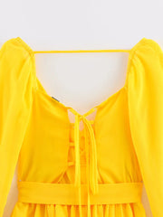 Yellow dress with puff sleeves on a white background