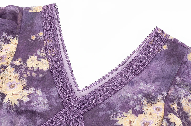 Close-up of the lace trim and v-neckline on a purple floral print dress.