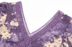 Close-up of the lace trim and v-neckline on a purple floral print dress.
