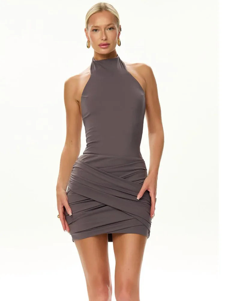 Woman wearing a gray halter neck dress on a white background