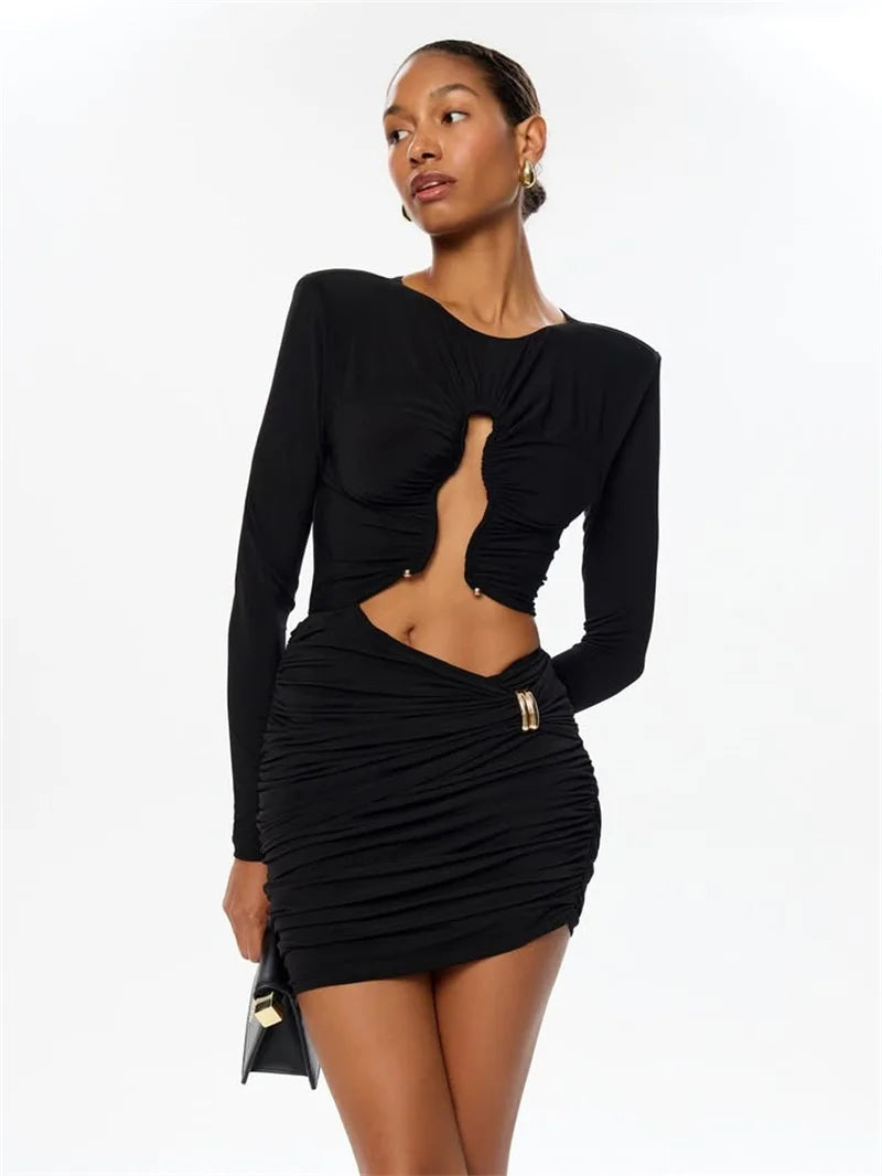 Woman wearing a black long-sleeve top and skirt set on a white background