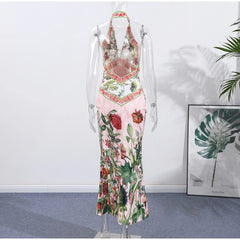Floral dress on a mannequin against a white wall with a plant in the corner.