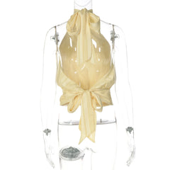 Mannequin wearing a beige halter top with a bow detail on a white background
