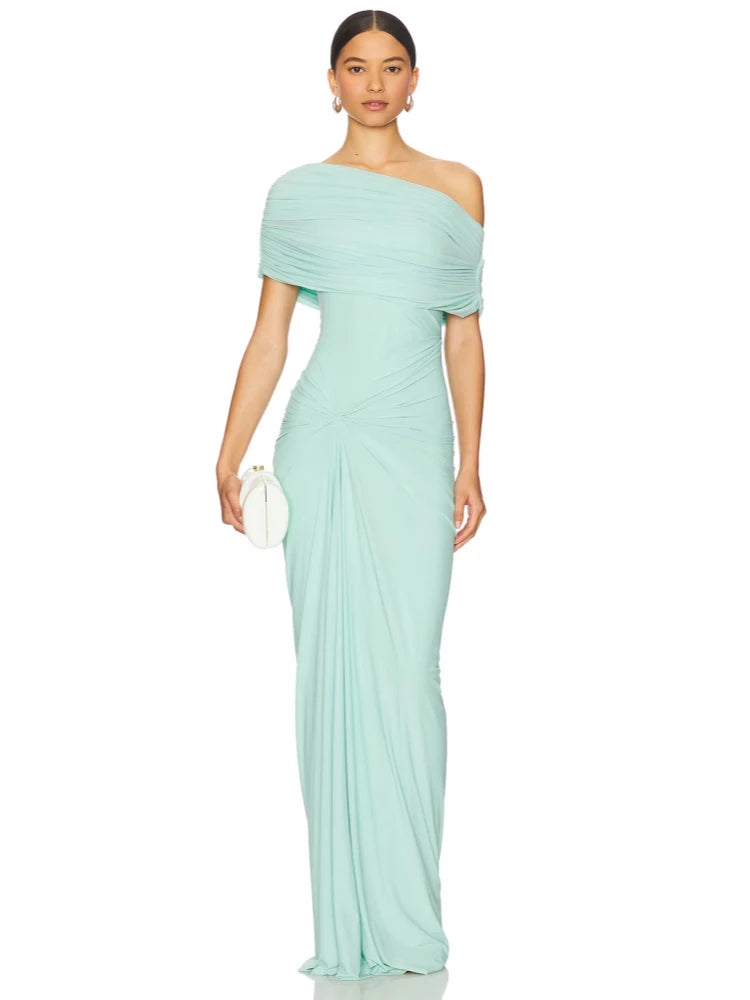 Woman wearing a light blue off-shoulder gown on a white background