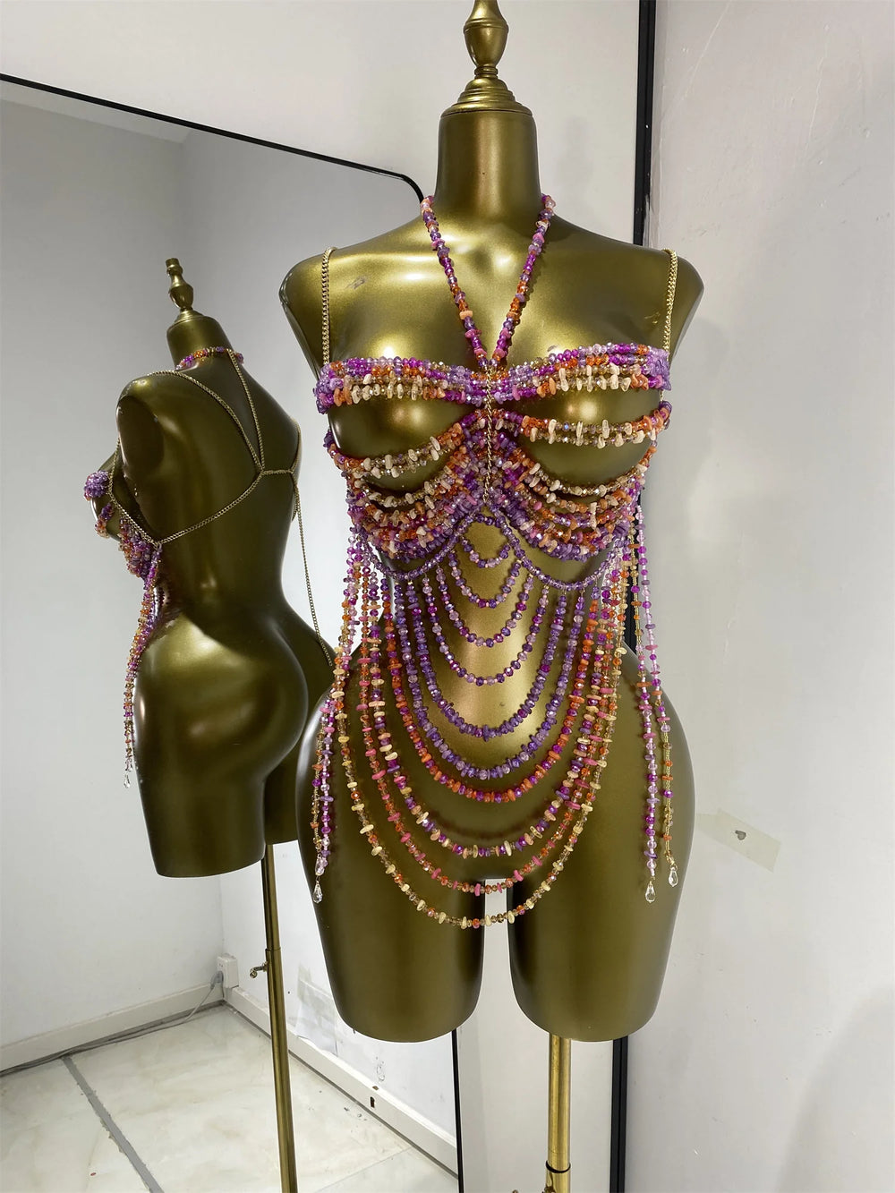 Beaded body jewelry swimwear set with purple, pink, and orange beads cascading down.