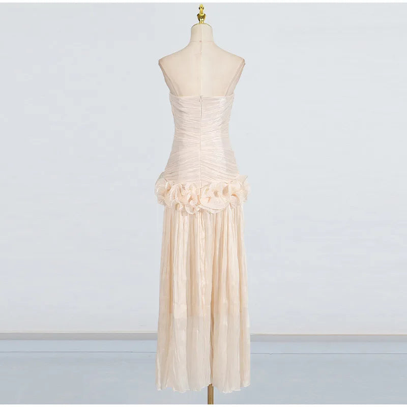 Beige strapless dress with floral details on a mannequin against a white background