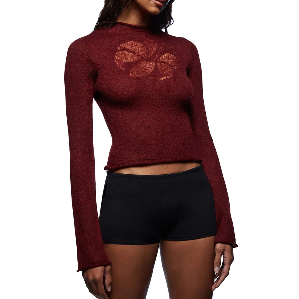 Maroon long-sleeve top with a leaf design worn by a person