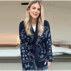 Woman wearing a navy blue patterned robe indoors.