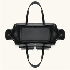 Black handbag with a reflective surface on a white background