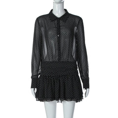 Black polka dot dress on a mannequin against a white background