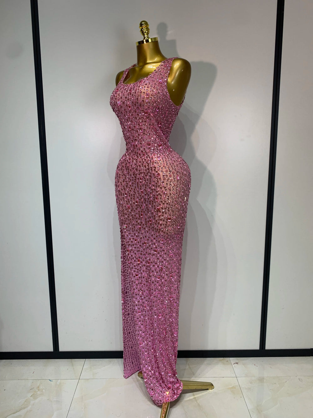 Side view of a pink diamond-embellished maxi dress on a mannequin