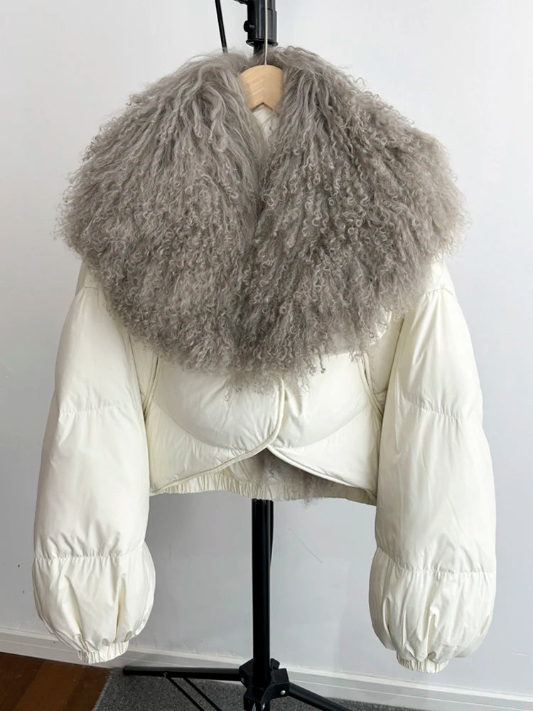 White cropped puffer jacket with a large grey curly textured fur collar and full sleeves.