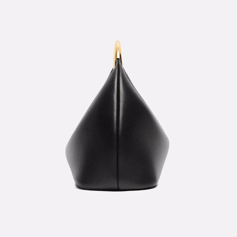 Black geometric bag with gold accent on a light gray background