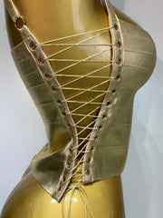 Side view of gold bandage corset top showcasing lace-up closure