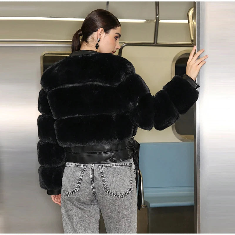 Person wearing a black fur coat entering a subway train.