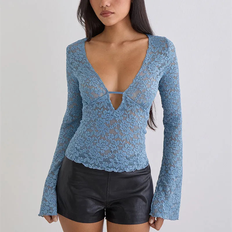 Blue lace long-sleeve top worn by a model on a plain background