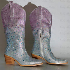 Pair of glittery cowboy boots with a gradient color effect on a light background
