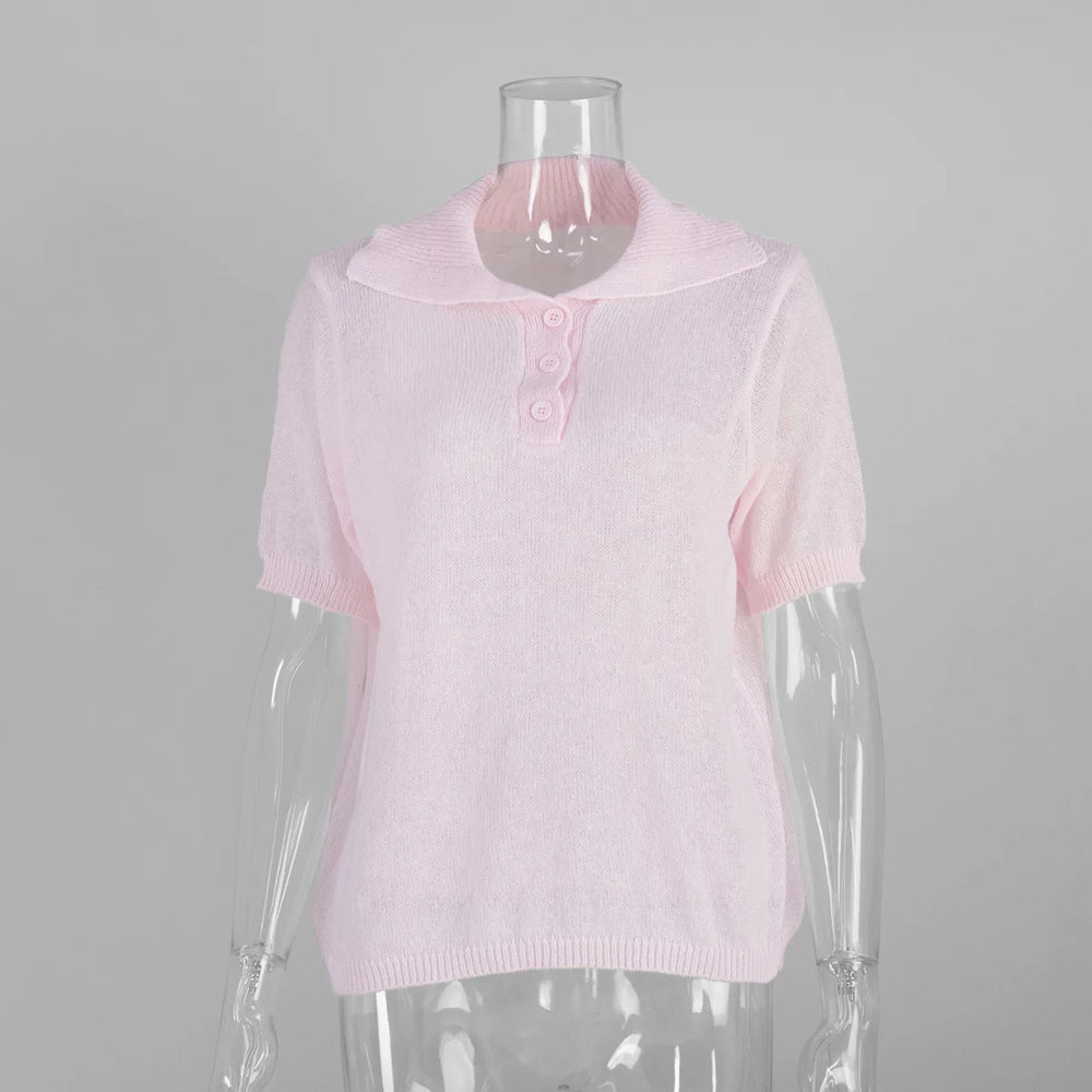 Pink knitted top on a mannequin against a gray background