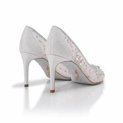 Pair of silver high-heeled shoes with embellishments on a white background