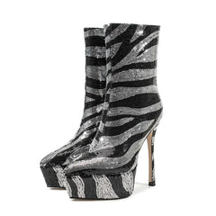 Black and silver striped high-heeled platform boots on a white background