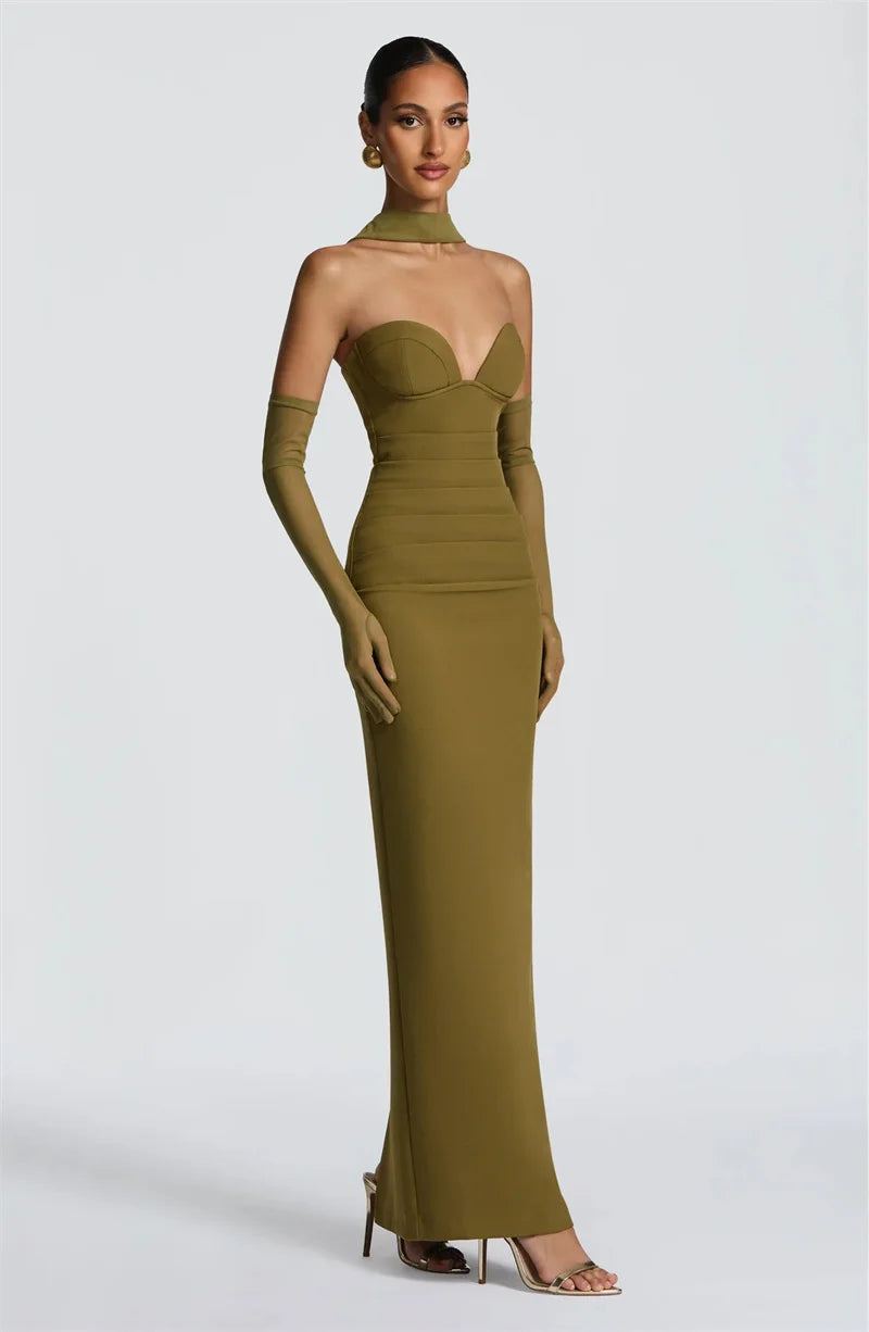 Woman wearing a green evening gown with a plain background