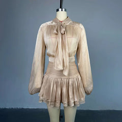 Beige dress on a mannequin against a gray background