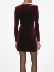 Maroon velvet dress with long sleeves on a white background