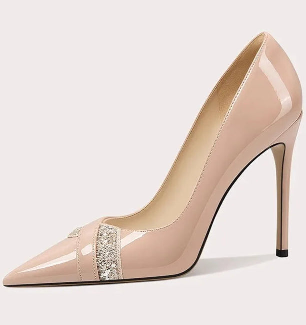 Beige high-heeled shoe with a decorative strap on a white background