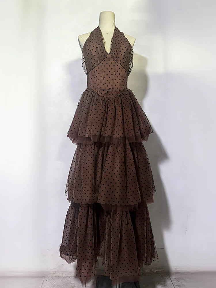 Brown polka dot dress on a mannequin against a white background