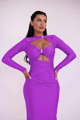 Woman wearing a purple dress with cut-out design on a white background